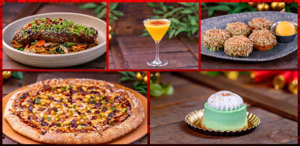 Assorted gourmet dishes including a pasta with vegetables and sauce, a cocktail, dessert bites, a cheese pizza, and a layered cake on a wooden table