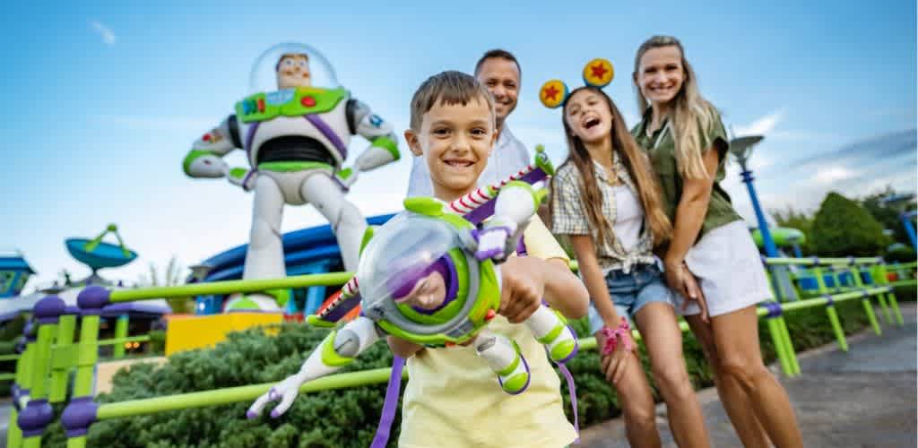 Family enjoying a day at an amusement park with rides and attractions in the background
