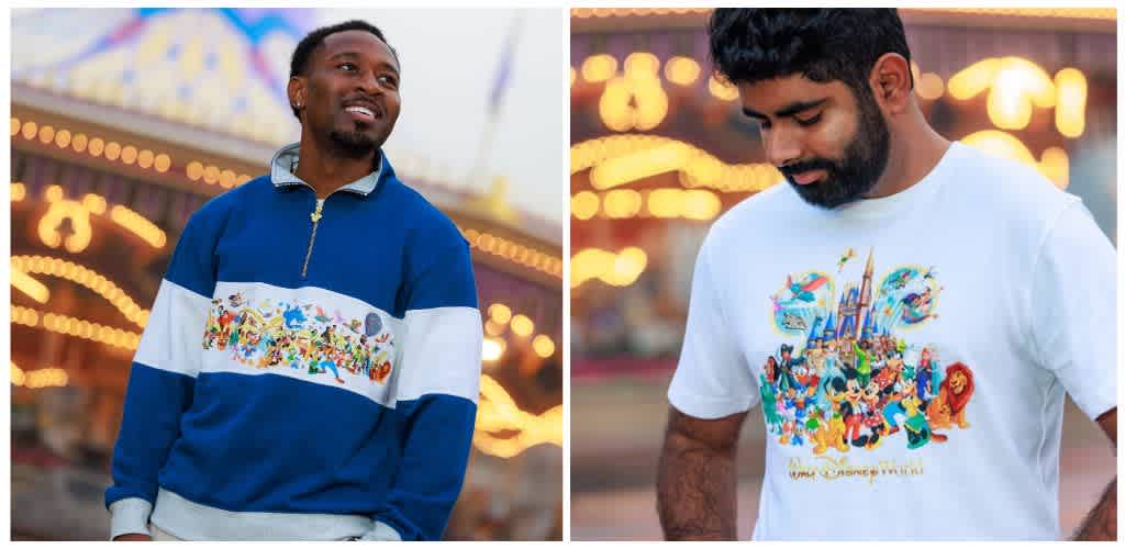 Two men at a fairground wearing Disney-themed apparel with colorful carousel lights in the background