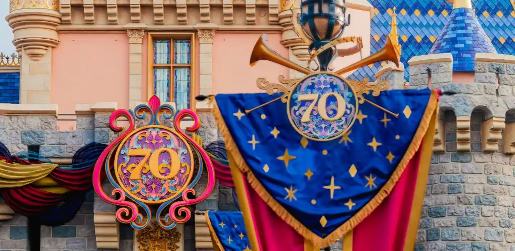 Disneyland's 70th anniversary celebration featuring colorful decorations, characters, and festive crowds enjoying the event.