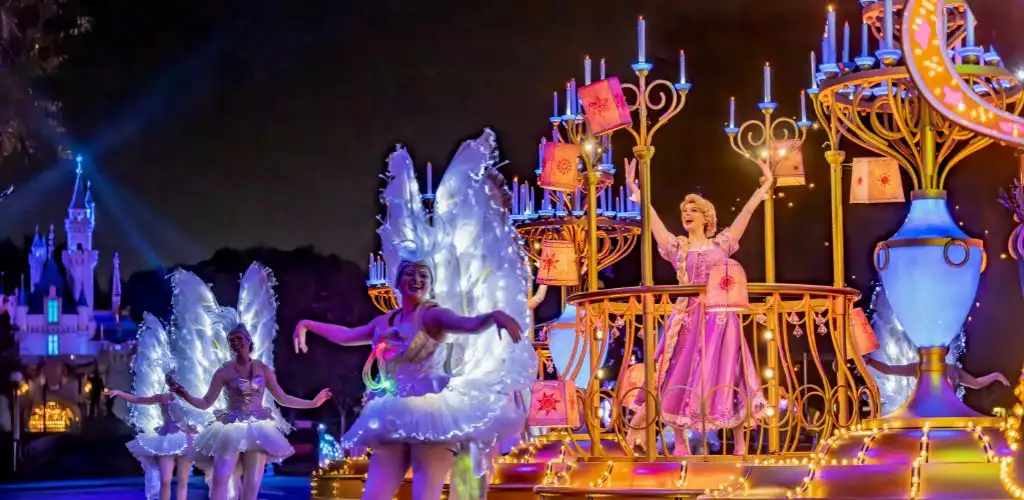 Disneyland night parade featuring vibrant lights and festive decorations illuminating the joyful atmosphere.