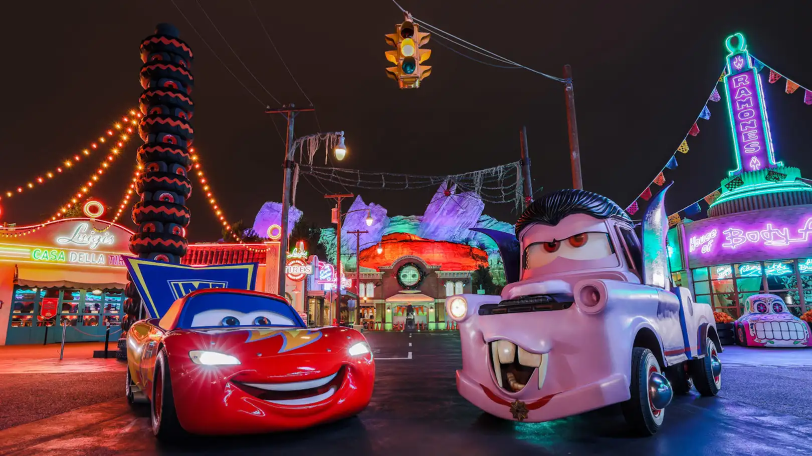 Colorful lights illuminate Disneyland parades at night, creating a vibrant and festive atmosphere for attendees.