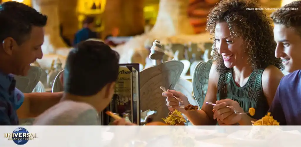Family enjoying a themed dining experience at Universal Orlando Resort, savoring delicious meals in an immersive and fantastical restaurant setting.